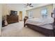 Spacious bedroom with carpeted floors, ceiling fan, and large windows with natural light at 2508 Coach House Loop, Castle Rock, CO 80109