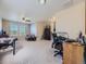 Spacious bonus room with plush carpeting, ceiling fan, game table, and adjacent desk workspace at 2508 Coach House Loop, Castle Rock, CO 80109
