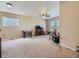 Large, carpeted bonus room featuring a ceiling fan and windows for natural light at 2508 Coach House Loop, Castle Rock, CO 80109