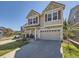 Attractive two-story home with neutral siding, red shutters, front porch and an attached two-car garage at 2508 Coach House Loop, Castle Rock, CO 80109