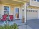 Inviting front porch with seating and an charming entrance to the house at 2508 Coach House Loop, Castle Rock, CO 80109
