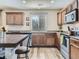Well lit kitchen featuring wood cabinets, stainless steel appliances, and light wood flooring at 2508 Coach House Loop, Castle Rock, CO 80109