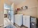 Convenient laundry room with modern washer and dryer, overhead shelving, and ample storage at 2508 Coach House Loop, Castle Rock, CO 80109