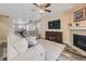 Comfortable living room features a fireplace, TV, and seamlessly connects to the dining area at 2508 Coach House Loop, Castle Rock, CO 80109