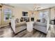 Bright living room with a fireplace, ceiling fan, wood-look floors, and neutral decor at 2508 Coach House Loop, Castle Rock, CO 80109
