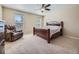 Comfortable bedroom with a wooden bed frame, recliner, and neutral carpet at 2508 Coach House Loop, Castle Rock, CO 80109