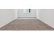 Bright bedroom featuring plush carpeting, white walls, and a window providing natural light at 9277 Truckee Ct, Commerce City, CO 80022