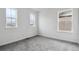 Bright bedroom featuring multiple windows and plush carpeting at 9277 Truckee Ct, Commerce City, CO 80022