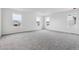 Spacious bedroom with ample natural light from multiple large windows and neutral carpeting at 9277 Truckee Ct, Commerce City, CO 80022