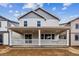 Two-story home featuring gray siding, a covered front porch, and a spacious yard at 9277 Truckee Ct, Commerce City, CO 80022