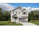 Charming two-story home with light gray siding, blue shutters, and an attached two-car garage at 9277 Truckee Ct, Commerce City, CO 80022