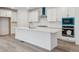 Modern kitchen with white cabinets, a central island, and stainless steel appliances at 9277 Truckee Ct, Commerce City, CO 80022