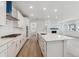 Open concept kitchen featuring stainless steel appliances, a large island, and hardwood floors at 9277 Truckee Ct, Commerce City, CO 80022