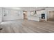 Open-concept living area with a modern kitchen, fireplace, and hardwood flooring at 9277 Truckee Ct, Commerce City, CO 80022