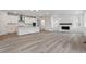 Open-concept living space with a fireplace, hardwood flooring, and bright, natural light at 9277 Truckee Ct, Commerce City, CO 80022
