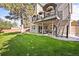 Spacious backyard featuring a large deck with outdoor seating and a lush green lawn at 6242 Shea Pl, Highlands Ranch, CO 80130