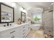 Modern bathroom features a dual vanity, soaking tub, walk-in shower, and stylish finishes at 6242 Shea Pl, Highlands Ranch, CO 80130