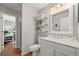 Cozy bathroom with a single vanity, framed mirror, and a shower with a partial view into the office at 6242 Shea Pl, Highlands Ranch, CO 80130