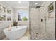 Bright bathroom featuring a freestanding tub, walk-in shower, and stylish tile at 6242 Shea Pl, Highlands Ranch, CO 80130
