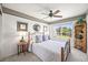 Cozy bedroom with a metal frame bed, soft carpet, and natural light from a large window at 6242 Shea Pl, Highlands Ranch, CO 80130