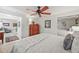 Bright bedroom features a ceiling fan, mirrored closet, and neutral decor at 6242 Shea Pl, Highlands Ranch, CO 80130