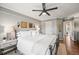Comfortable bedroom features a large bed with white linens, modern lighting, and neutral wall colors at 6242 Shea Pl, Highlands Ranch, CO 80130