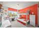 ' bedroom with a bunk bed, desk and bright orange accent wall at 6242 Shea Pl, Highlands Ranch, CO 80130