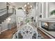 Elegant dining room with soaring ceilings, fireplace, and a large chandelier perfect for entertaining guests at 6242 Shea Pl, Highlands Ranch, CO 80130