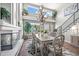 Bright, open dining room featuring a fireplace, large windows, and stylish decor and adjoins the staircase at 6242 Shea Pl, Highlands Ranch, CO 80130