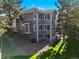 Exterior view of gray home with multiple windows, landscaped yard, and large trees at 6242 Shea Pl, Highlands Ranch, CO 80130