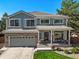 Charming two-story home featuring a well-manicured lawn and inviting front porch at 6242 Shea Pl, Highlands Ranch, CO 80130