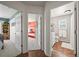 Hallway view showcasing multiple bedrooms and a full bath, with hardwood floors at 6242 Shea Pl, Highlands Ranch, CO 80130