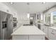 Modern kitchen with stainless steel appliances, quartz countertops, and ample cabinet space with an island at 6242 Shea Pl, Highlands Ranch, CO 80130
