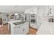 Bright, open kitchen with stainless steel appliances and a large island cooktop perfect for entertaining guests at 6242 Shea Pl, Highlands Ranch, CO 80130