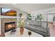 Cozy living room with a fireplace, comfortable seating, and open access to an adjacent room at 6242 Shea Pl, Highlands Ranch, CO 80130