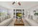 Bright living room with a built-in shelving unit, neutral decor, and a cozy atmosphere at 6242 Shea Pl, Highlands Ranch, CO 80130