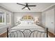 Serene main bedroom with neutral tones, large windows, a ceiling fan, and hardwood flooring at 6242 Shea Pl, Highlands Ranch, CO 80130