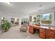 Bright office space with a large window, wooden desk, and comfortable seating for an efficient and productive work environment at 6242 Shea Pl, Highlands Ranch, CO 80130