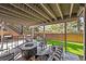 Covered patio with modern seating and fire pit perfect for outdoor entertainment and relaxation at 6242 Shea Pl, Highlands Ranch, CO 80130