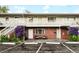 Apartment building featuring brick facade, painted stairs and railings, and charming purple flowers at 3705 Quail St # 4, Wheat Ridge, CO 80033