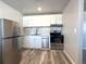 Updated kitchen featuring white cabinets and stainless steel appliances at 3705 Quail St # 4, Wheat Ridge, CO 80033