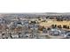 Wide aerial view of a neighborhood featuring single-Gathering homes and open spaces with ponds at 10995 Quintero St, Commerce City, CO 80022
