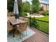 Inviting backyard deck with a dining table and view of a fire pit and well-maintained green lawn at 10995 Quintero St, Commerce City, CO 80022