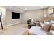 Finished basement area featuring a comfortable sectional sofa and a large-screen television at 10995 Quintero St, Commerce City, CO 80022