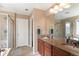 Bathroom featuring double vanity, a tiled floor, and glass shower with separate tub at 10995 Quintero St, Commerce City, CO 80022