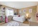 Charming bedroom with white daybed, bookshelves, plush carpet, and decor details at 10995 Quintero St, Commerce City, CO 80022