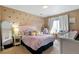 Bright bedroom featuring a pink bed, a wicker chair, desk, and heart decals on the walls at 10995 Quintero St, Commerce City, CO 80022