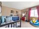 Cozy bedroom with day bed, bright window, and charming decor at 10995 Quintero St, Commerce City, CO 80022