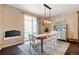 Charming dining room with stylish light fixture, a sliding glass door to the patio, and hardwood flooring at 10995 Quintero St, Commerce City, CO 80022