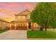 Beautiful two-story home featuring an attached garage, lovely porch, well-manicured lawn, and professional landscaping at 10995 Quintero St, Commerce City, CO 80022